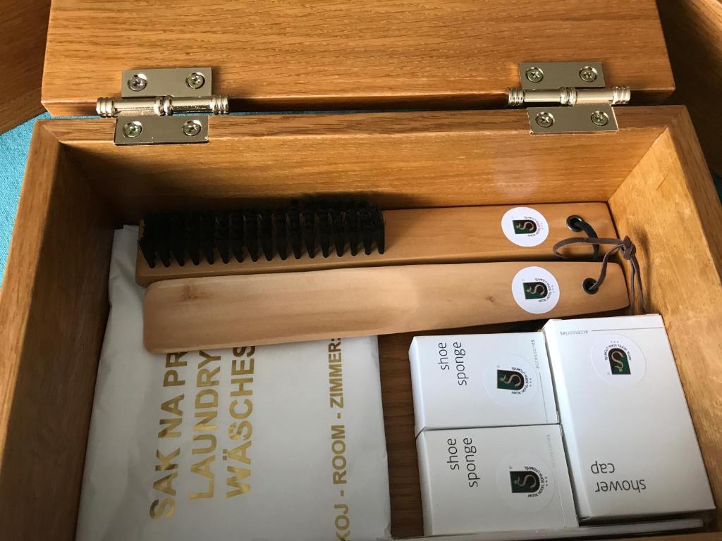 a wooden box filled with books and a wooden comb at Antik Hotel Sofia in Litomyšl