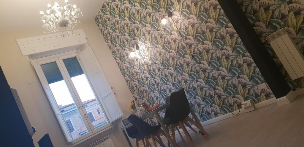 a room with a wall with a large flower mural at B&B Lumiere Roma in Rome