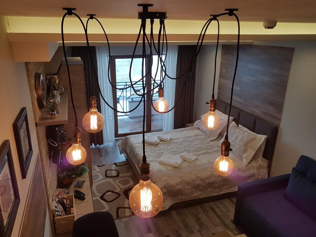 a bedroom with a bed with lights on it at Ogi & Una Premijer 42 in Kopaonik