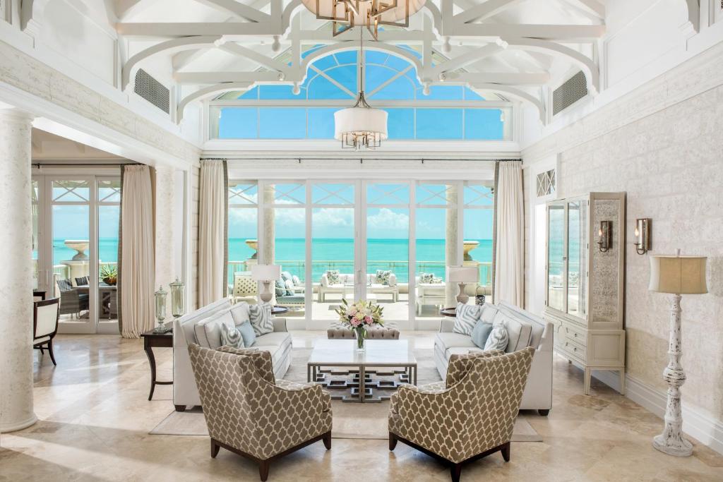 a living room with a couch and chairs and a table at The Shore Club Turks & Caicos in Grace Bay