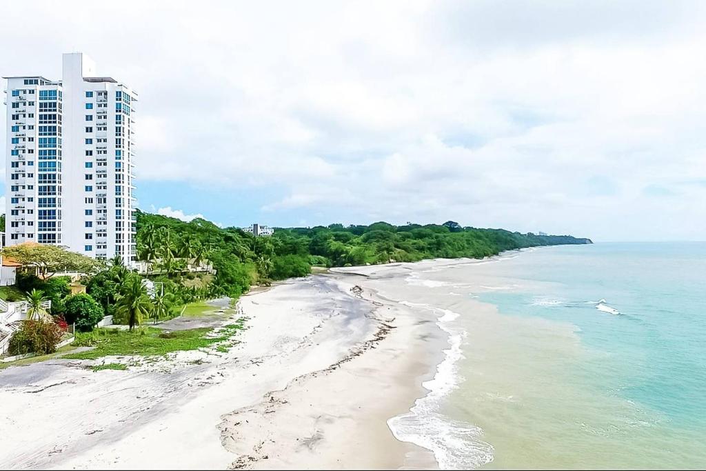 a view of the beach in front of a building at Sun n' Sand Retreat in La Chumicosa