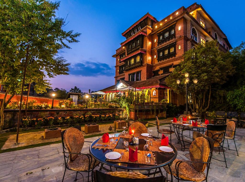 a patio with tables and chairs in front of a building at Hotel Heritage in Bhaktapur