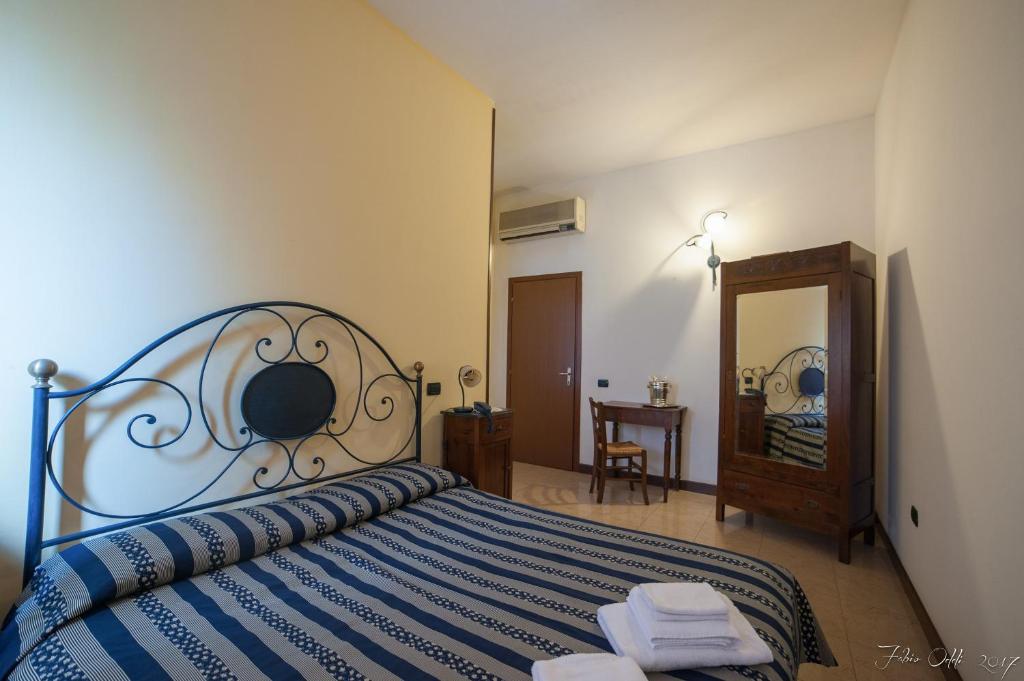 Postel nebo postele na pokoji v ubytování Albergo Martini
