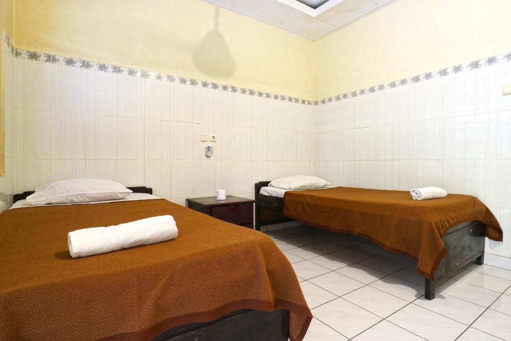 Postel nebo postele na pokoji v ubytování Gora Beach Inn