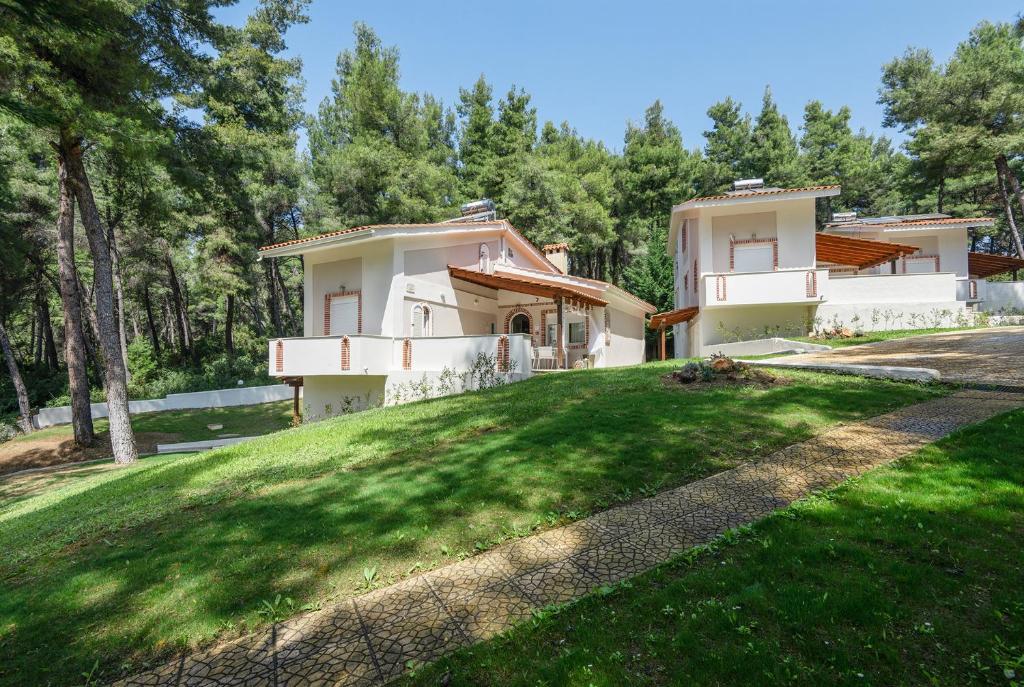 a view of a house with a yard at Ekatis Houses in Sani in Sani Beach