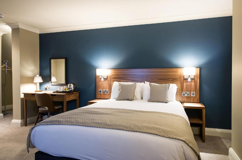 a hotel room with a large bed and a desk at Toby Carvery Birmingham by Innkeeper's Collection in Birmingham