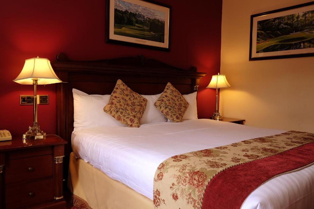 A bed or beds in a room at Racket Hall Country House Golf & Conference Hotel