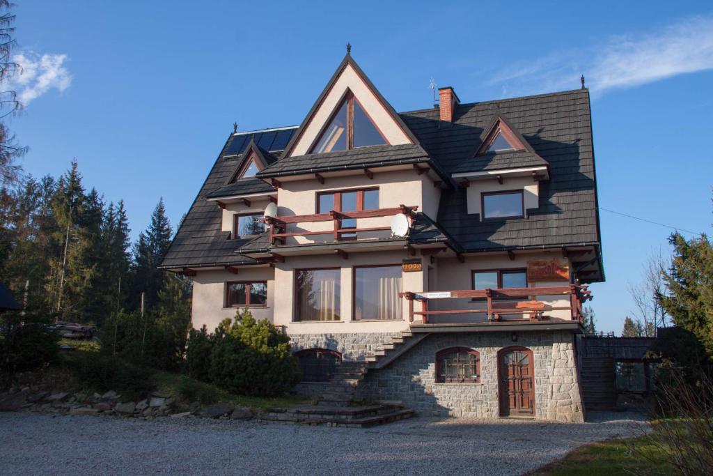 a large house with a black roof at Willa Wygrodzisko in Zakopane