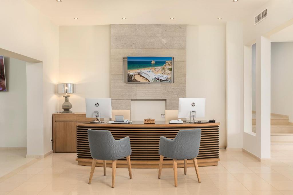 an office with a desk with two computers on it at Caneiros Luxury House & Suites in Ferragudo