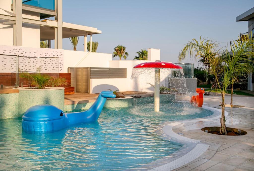 a pool with a blue rubber duck in the water at Asterias Beach Hotel in Ayia Napa