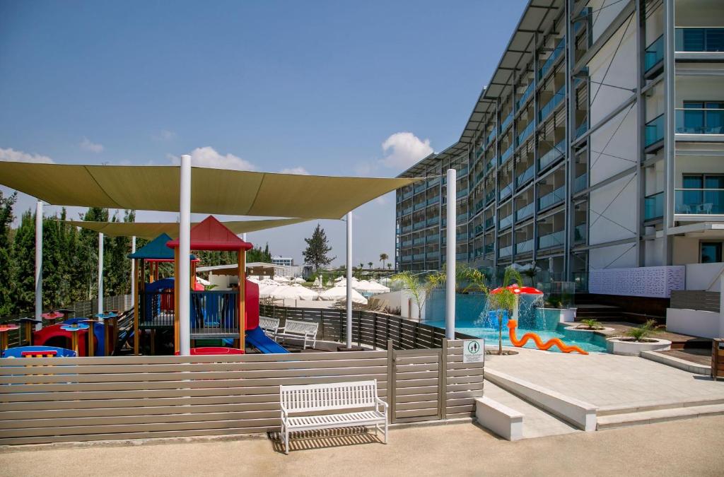 a playground in front of a building with a water park at Asterias Beach Hotel in Ayia Napa