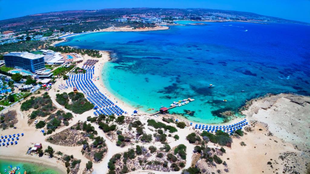 an aerial view of a beach and the ocean at Asterias Beach Hotel in Ayia Napa