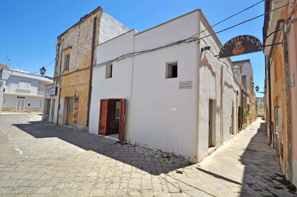 an alley in an old town with white buildings at Corte dei Marzani by Salento Affitti in Racale