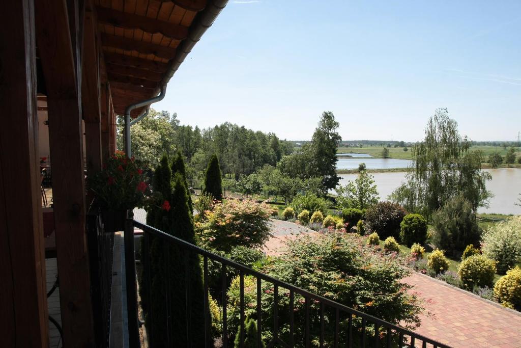 a balcony of a house with a view of a river at NASZ DWOREK in Dziergowice