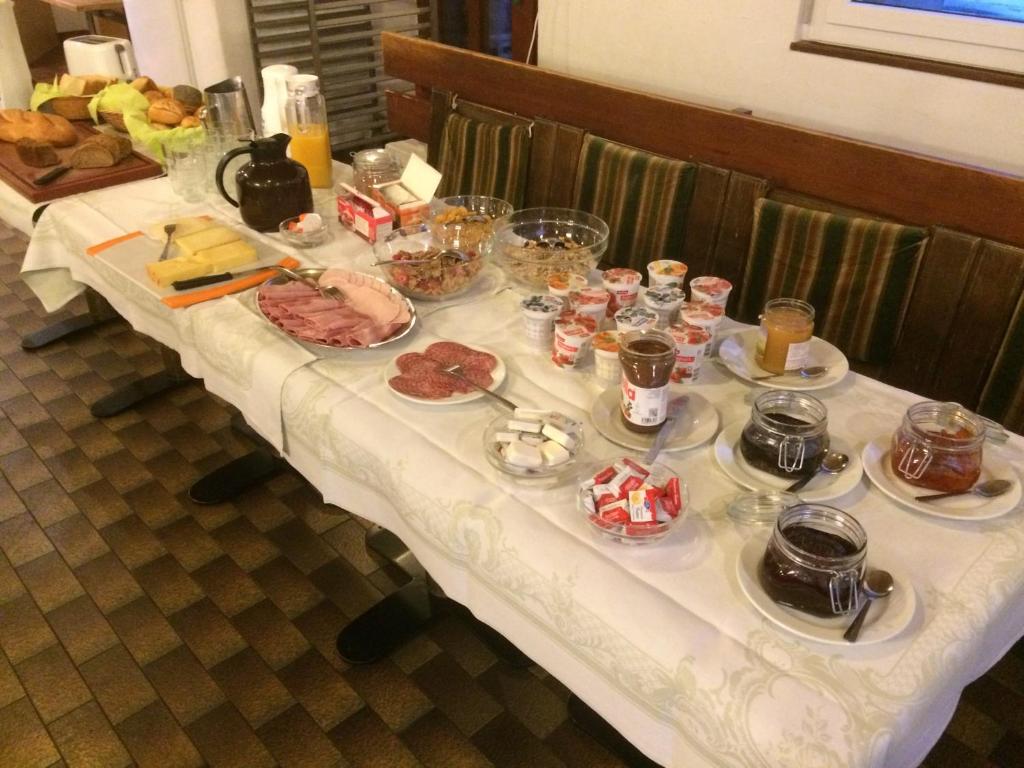 a white table with food on top of it at B&B Haus Granit Saas Grund in Saas-Grund