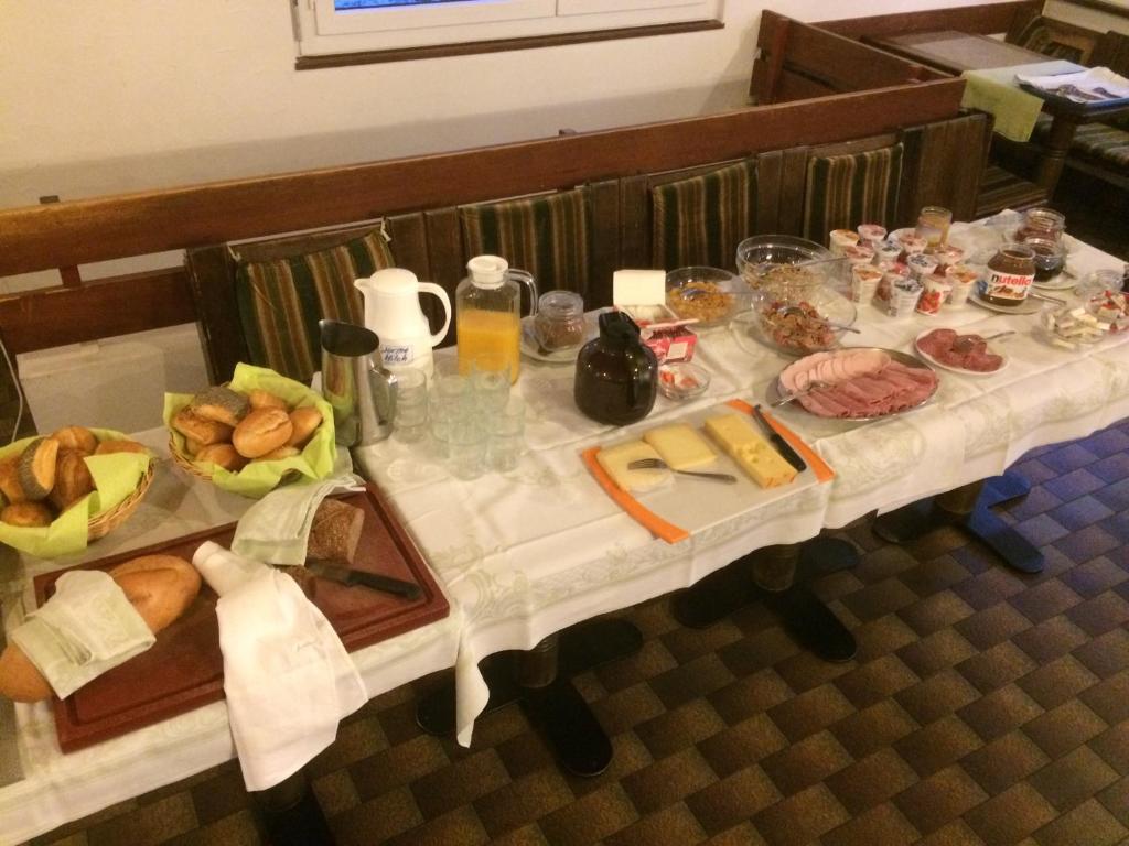 a table with bread and other foods on it at B&B Haus Granit Saas Grund in Saas-Grund