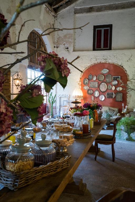 a long wooden table with food on top of it at Glamping Canonici di San Marco in Mirano