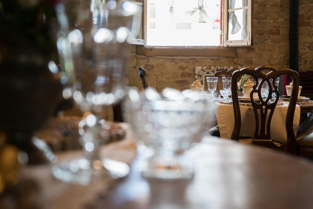 a wooden table with glasses on top of it at Glamping Canonici di San Marco in Mirano