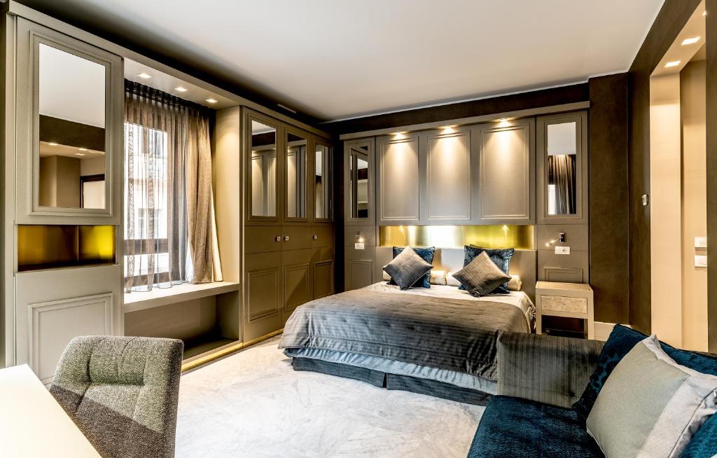 a bedroom with a bed and a couch at Palazzo Doglio in Cagliari