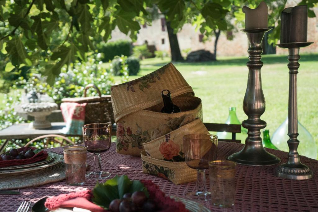 a table with a bag of wine and glasses on it at Glamping Canonici di San Marco in Mirano