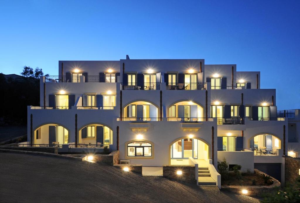 a large white building at night with lights at Anatoli in Agia Pelagia