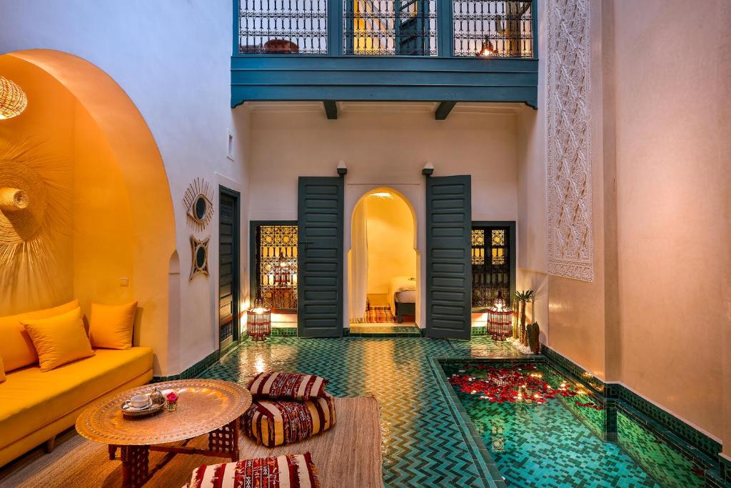 a living room filled with furniture next to a stairwell at Hotel & Spa Dar Baraka & Karam in Marrakesh