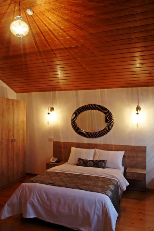 A bed or beds in a room at Belizia Hotel