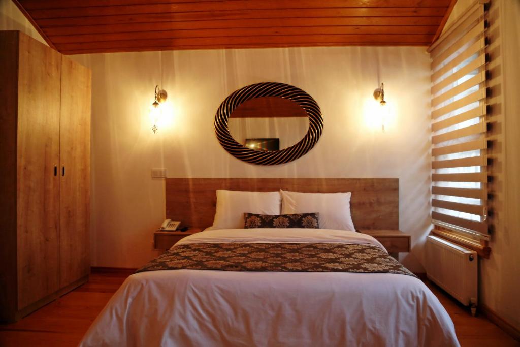 A bed or beds in a room at Belizia Hotel