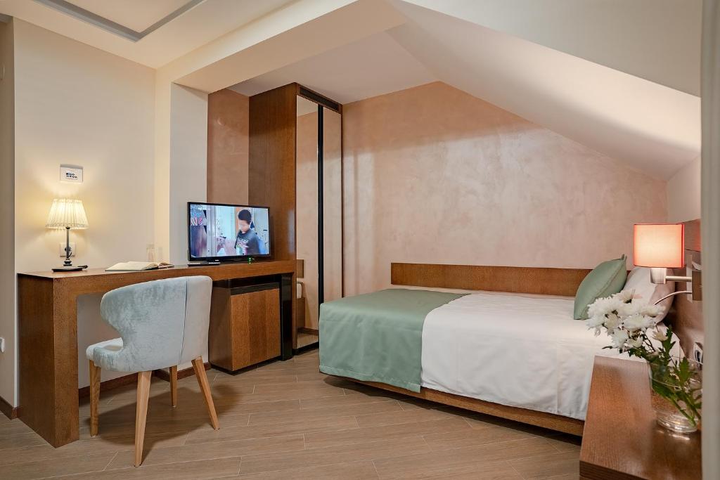 Postel nebo postele na pokoji v ubytování Rubicon Garni Hotel
