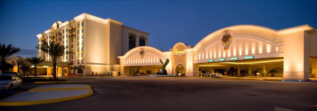 a large building with a parking lot in front of it at Paragon Casino Resort in Marksville