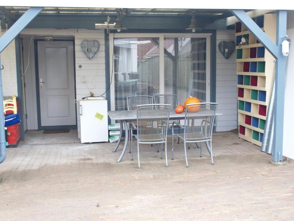 a table and chairs sitting on a patio at JaBaKi Child friendly home in Hoofddorp