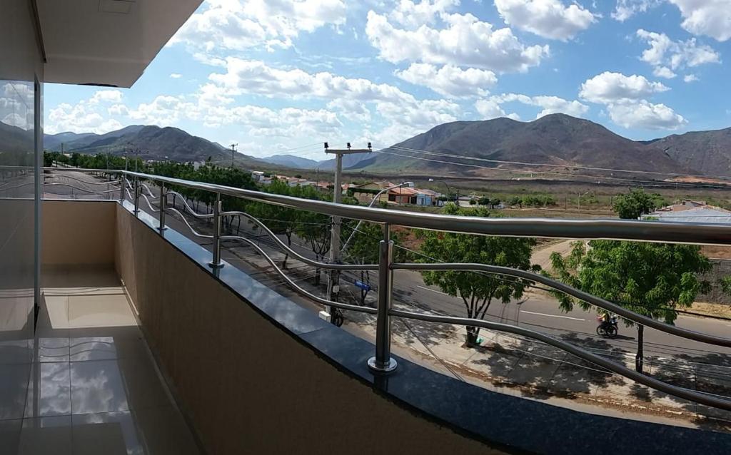 a balcony with a view of a road and mountains at Seller Hotel in Sobral