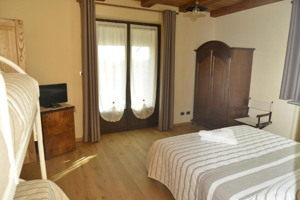 Postel nebo postele na pokoji v ubytování Agriturismo Ai Prüsot