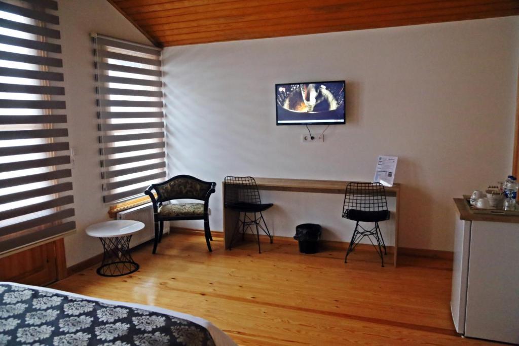 A bed or beds in a room at Belizia Hotel