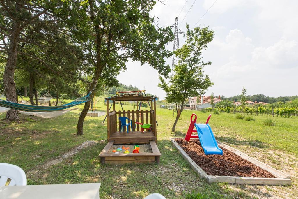 a park with a playground with a swing at Kamp Romantik - glamping in Labin