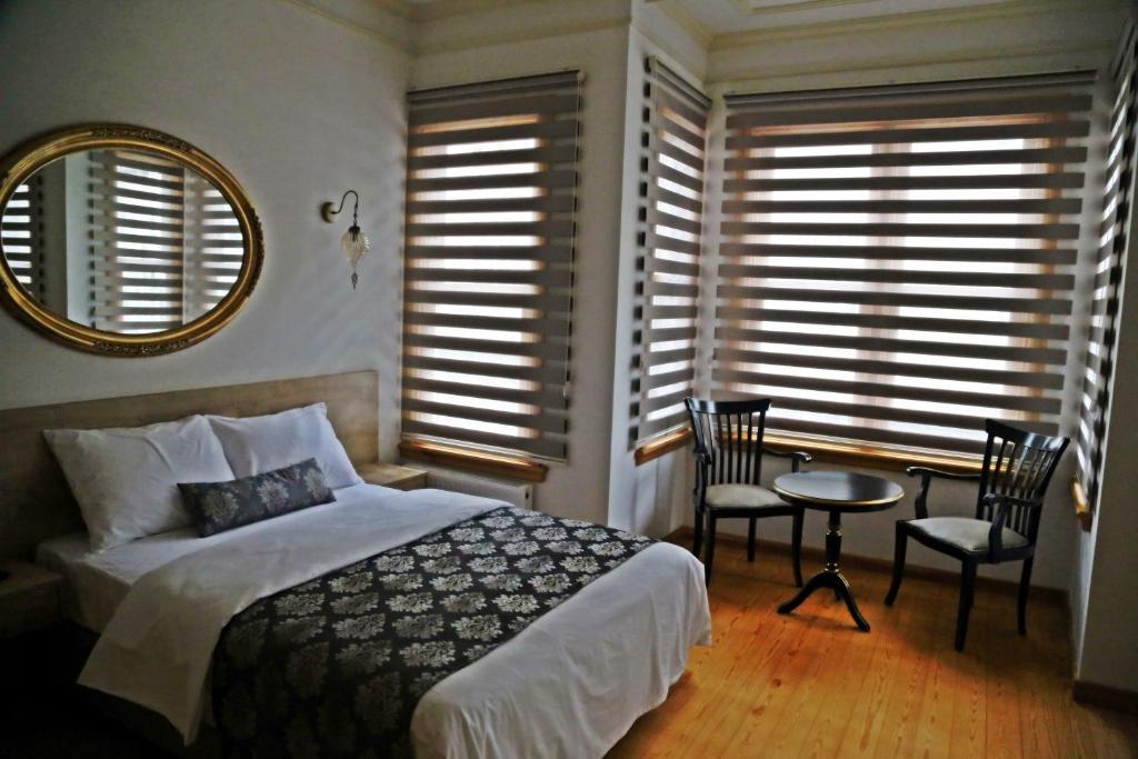 A bed or beds in a room at Belizia Hotel