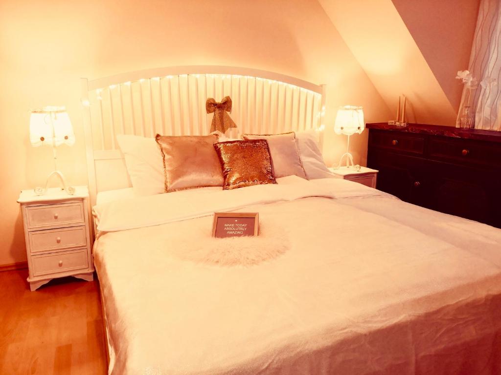a bedroom with a white bed with a book on it at Sandra's Juwel in Klagenfurt