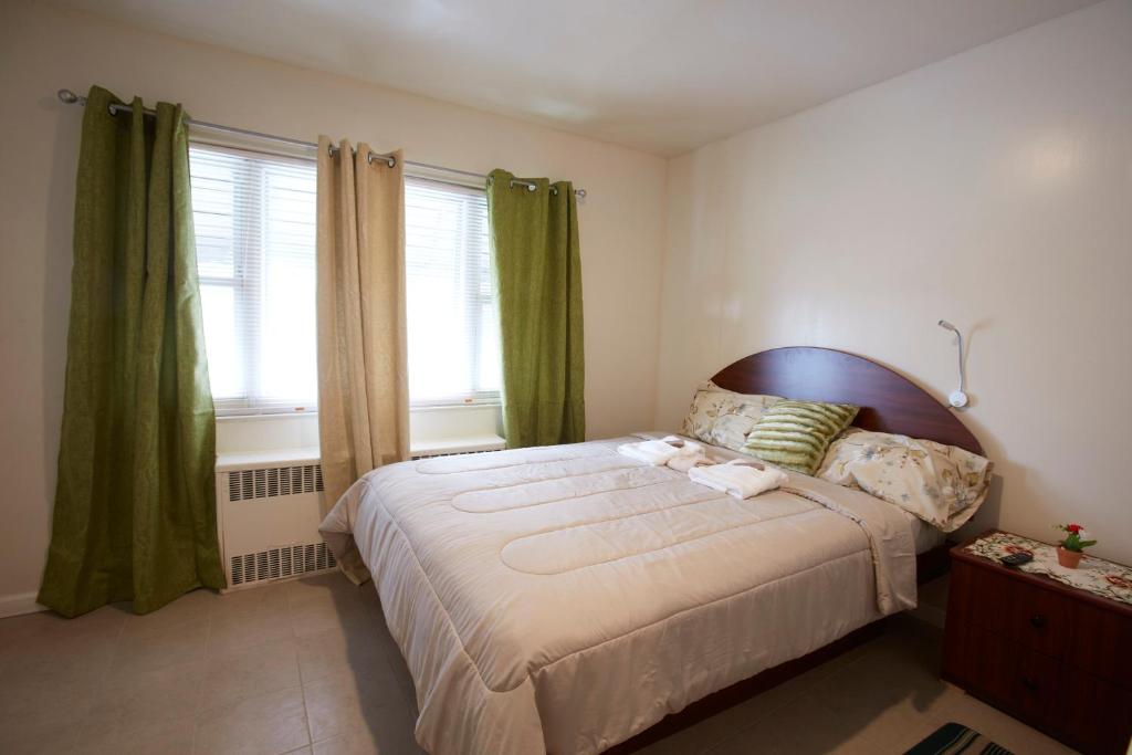 a bedroom with a large bed and a window at STUDIO&ONE BEDROOM APARTMENTS in Bronx