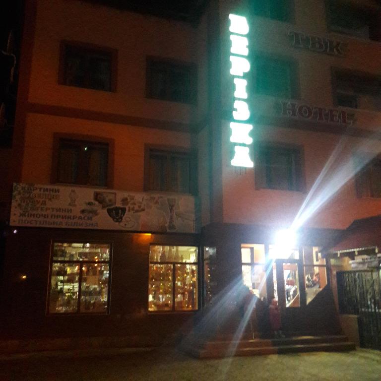 a building with a light in front of it at night at Berizka in Yaremche