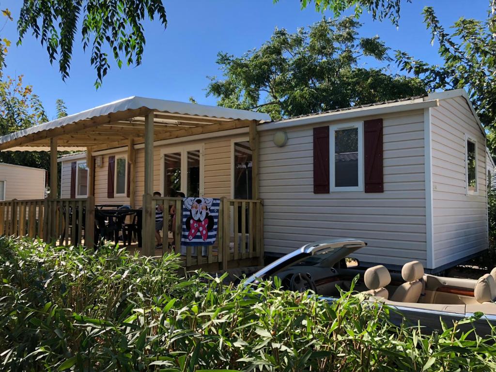 a tiny house with a porch and a gazebo at Dream holidays in Valras-Plage