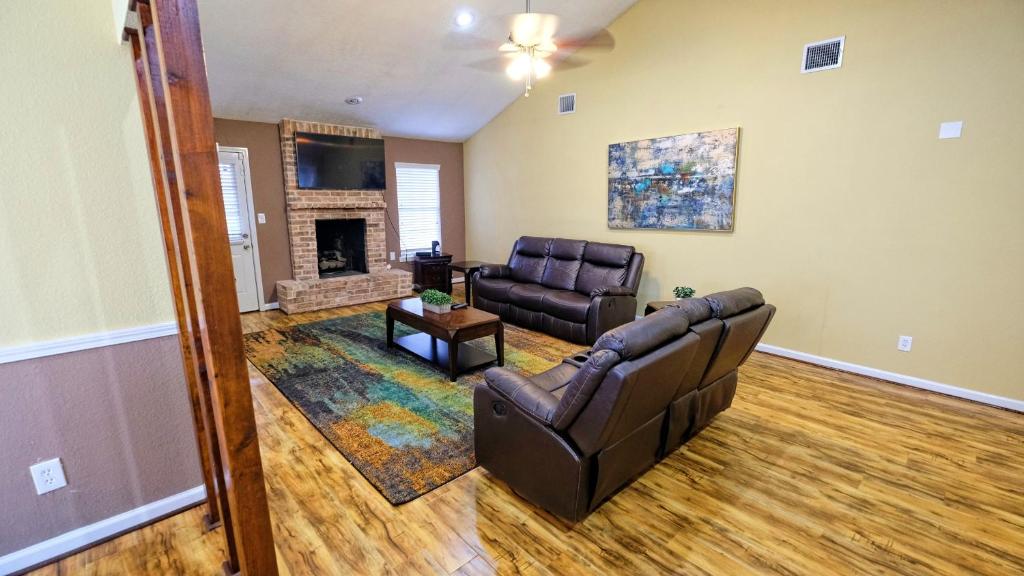 a living room with a couch and a fireplace at NRG, Medical Center, MM Park, Galleria, MD Anderson - Valley Bend in Missouri City