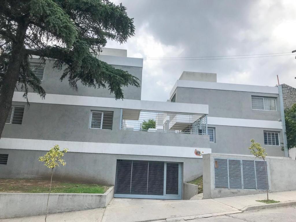 un gran edificio blanco con 2 plazas de garaje en Departamento Carlos paz en Villa Carlos Paz