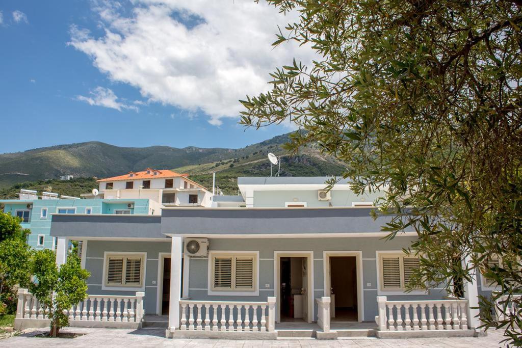 a white house with a fence in front of it at Aparthotel Fitimi in Borsh