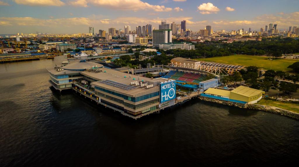 an aerial view of a city with a dock in the water at Hotel H2O in Manila