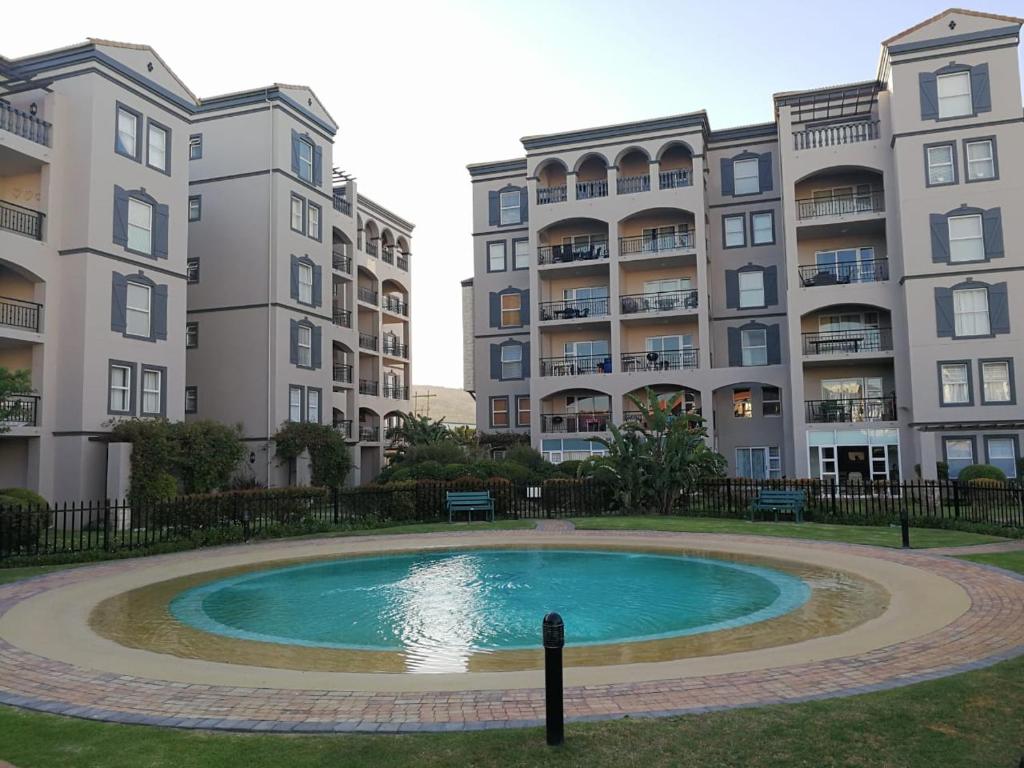 a pool in the middle of two apartment buildings at 11 Portobelo in Mossel Bay