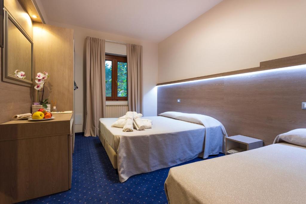 Postel nebo postele na pokoji v ubytování Hotel Aurora
