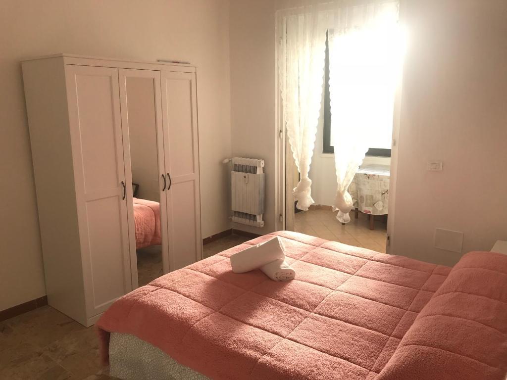 a bedroom with a bed and a large window at Home Sweet Home B&B in Pisa