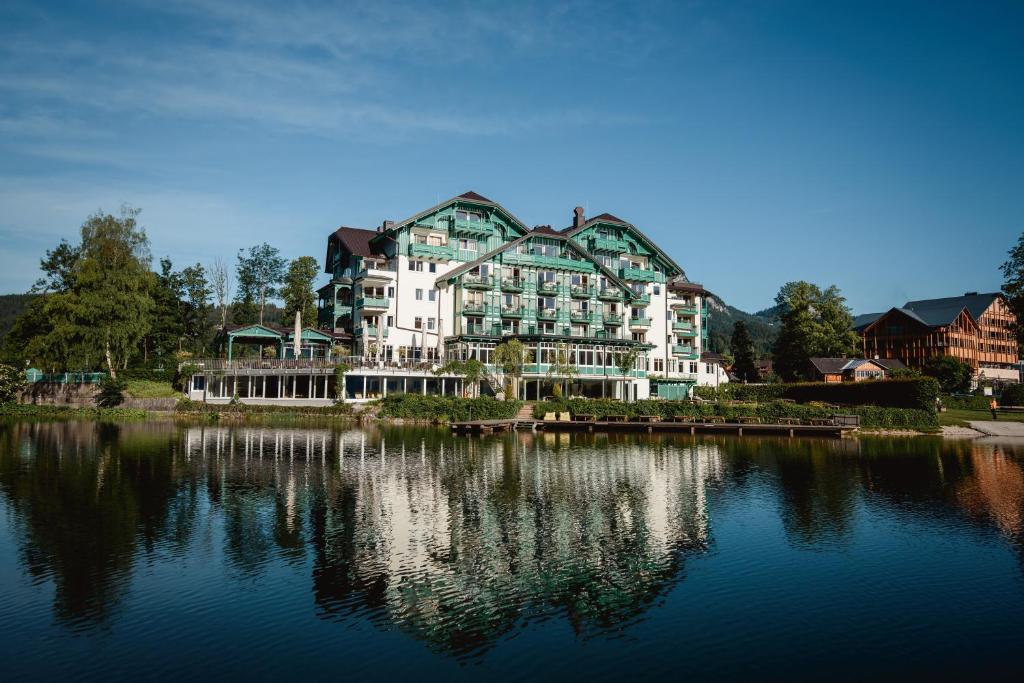 a large building sitting on the side of a lake at Seevilla Altaussee in Altaussee