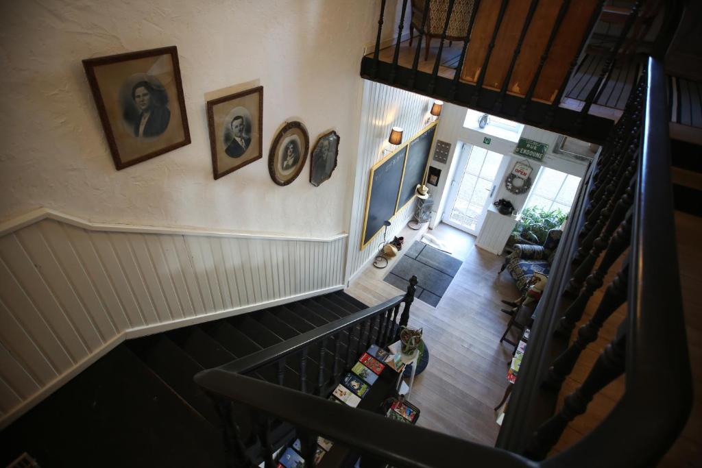 an overhead view of a staircase in a house with clocks on the wall at Le sentier des étangs in Barsy