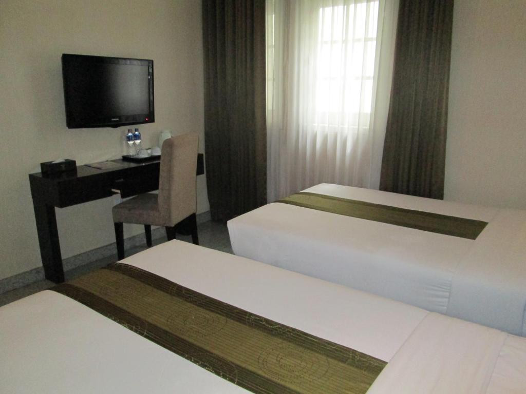 Postel nebo postele na pokoji v ubytování Vio Hotel Cimanuk Bandung